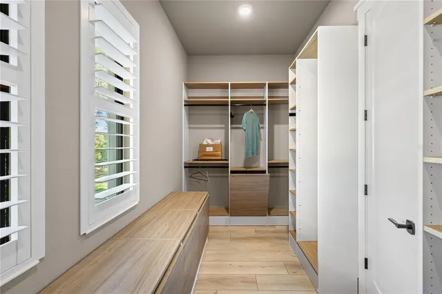 a bathroom with a granite countertop sink mirror vanity and toilet