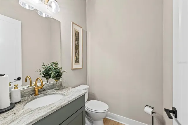 an aerial view of a house with a yard and lake view