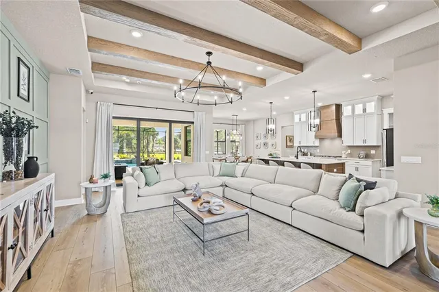 a living room with furniture a table and potted plants