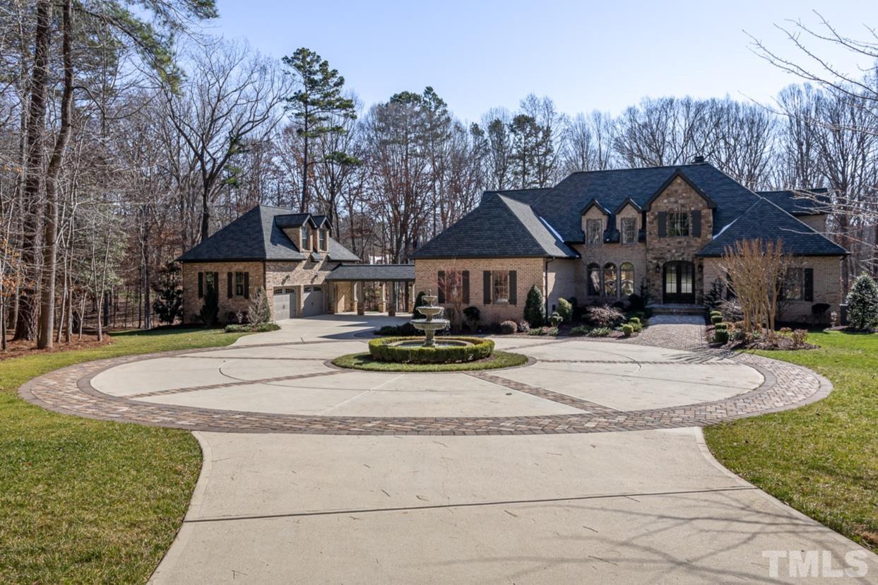 a front view of a house with yard and green space