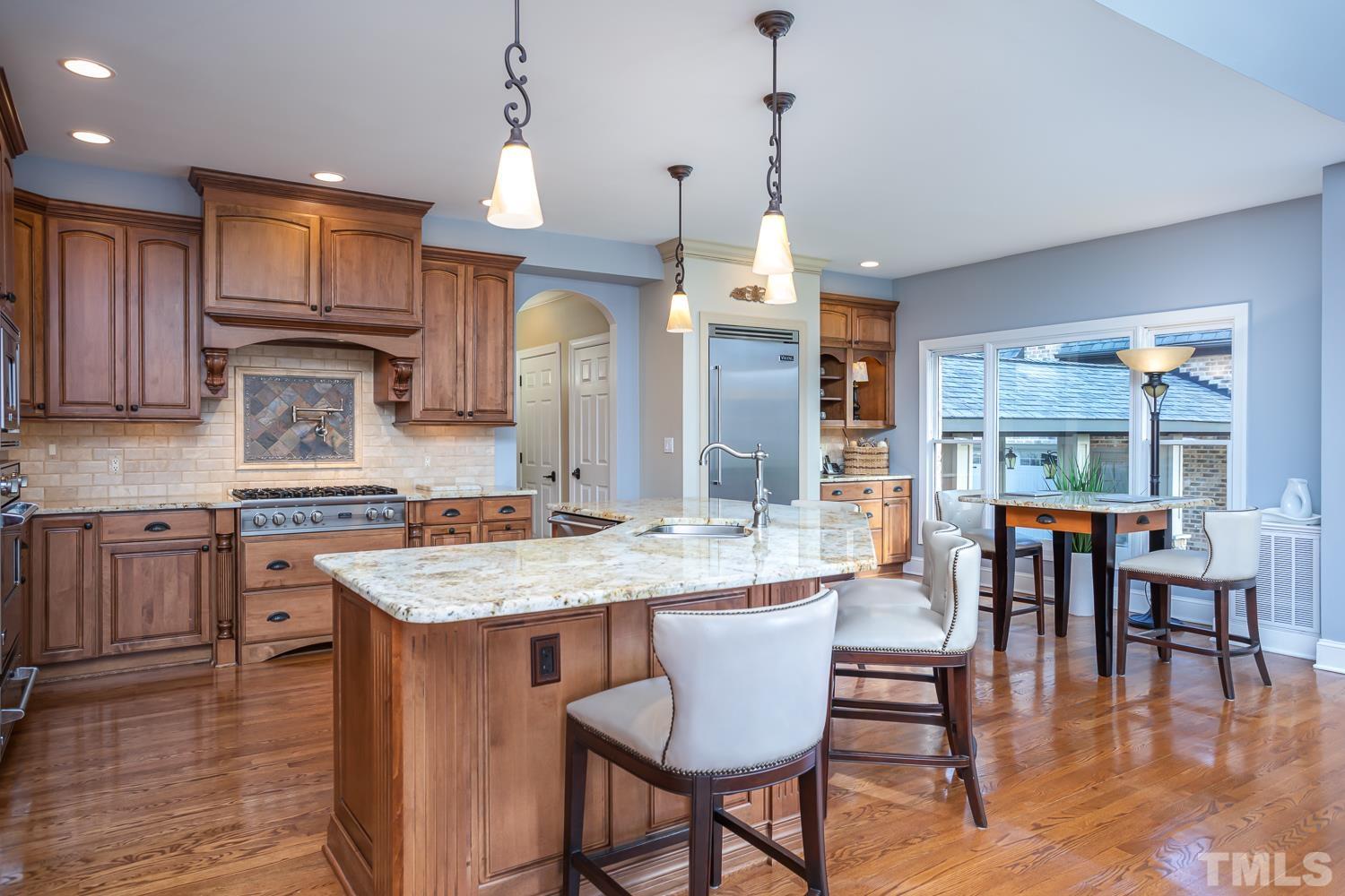 1616 Morning Mountain Road Raleigh, NC 27614 - Photo 14 of 86 a large kitchen with a table and chairs