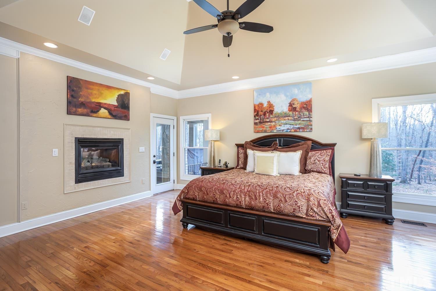 1616 Morning Mountain Road Raleigh, NC 27614 - Photo 23 of 86 a bedroom with a bed and a chandelier