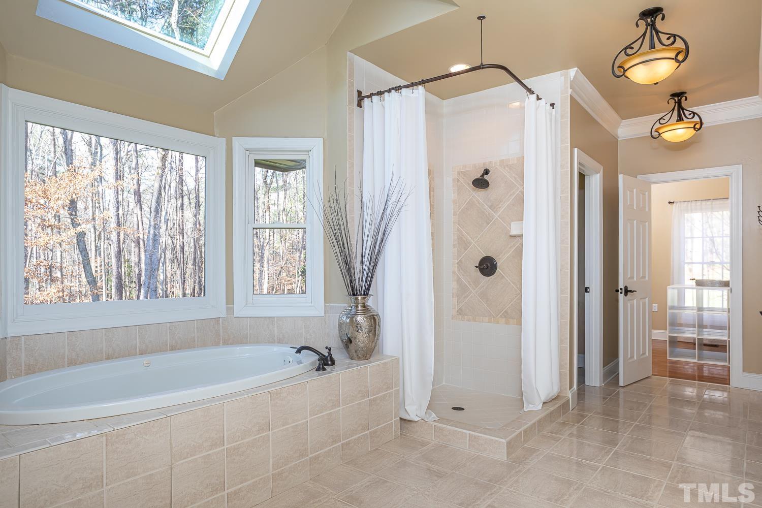 1616 Morning Mountain Road Raleigh, NC 27614 - Photo 24 of 86 a spacious bathroom with a bathtub and a shower