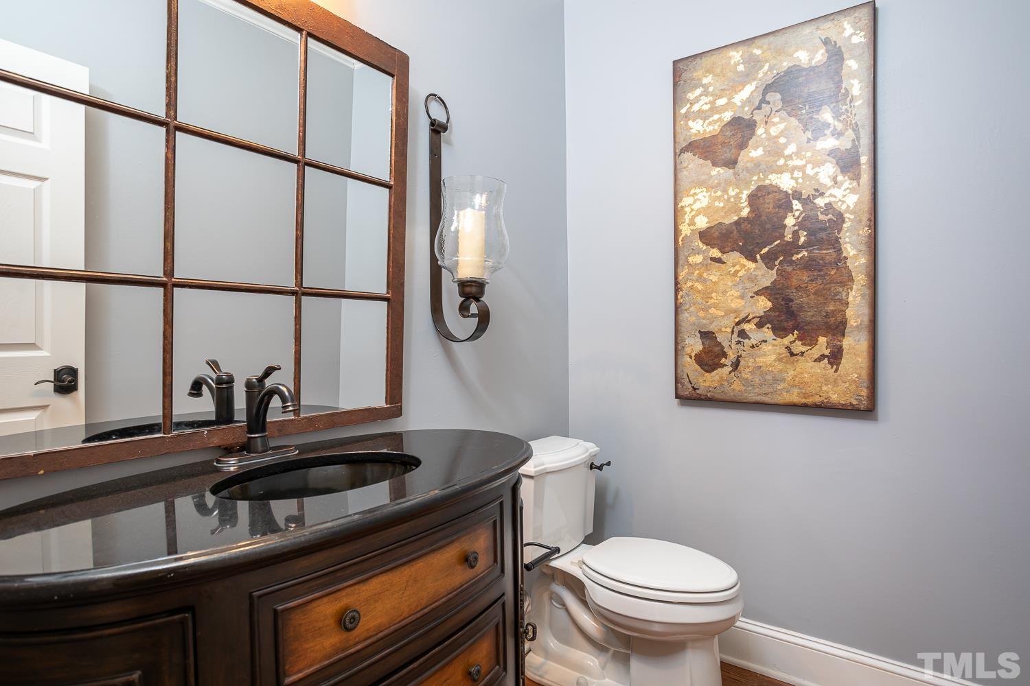 1616 Morning Mountain Road Raleigh, NC 27614 - Photo 26 of 86 a bathroom with a sink a toilet and a window