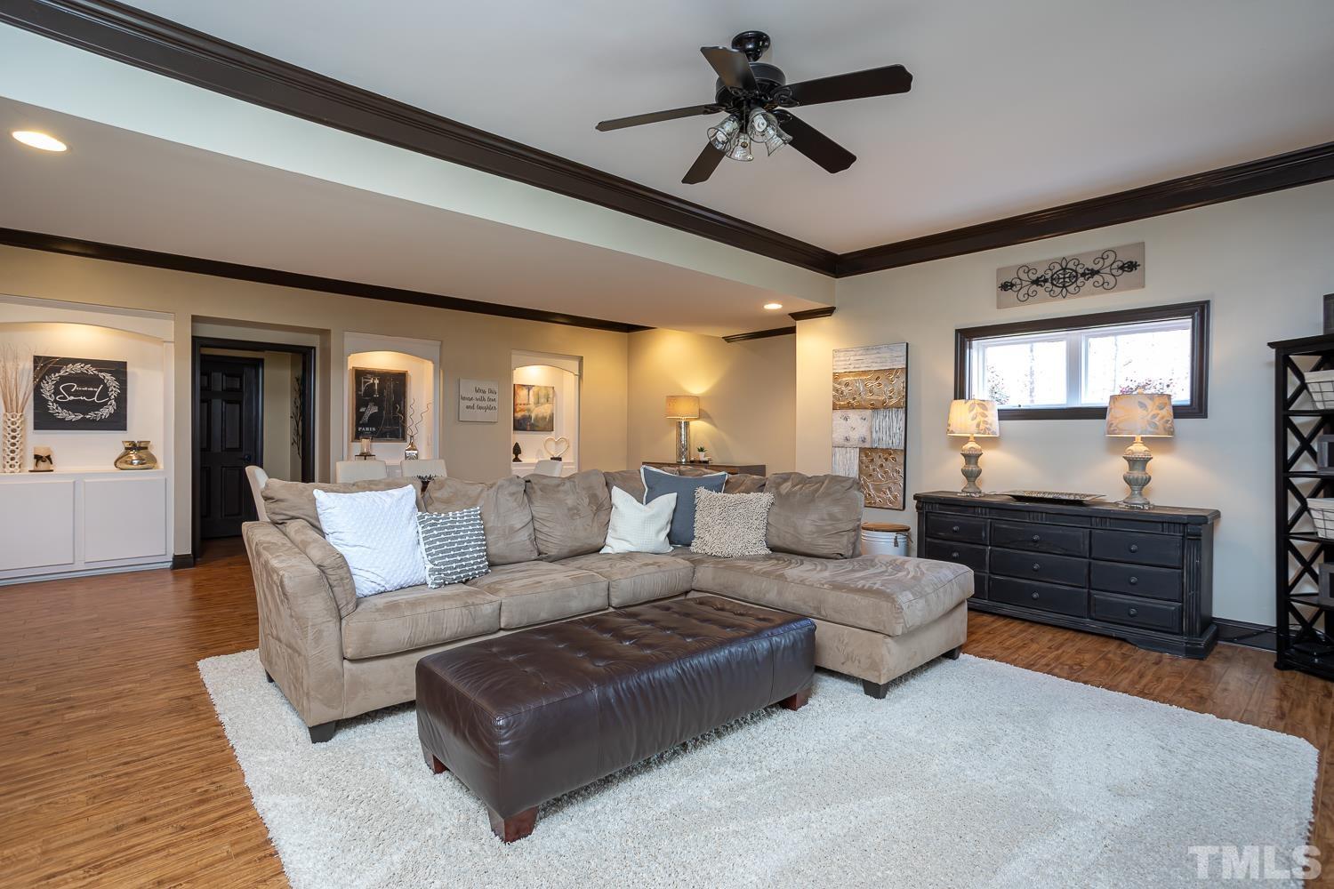 1616 Morning Mountain Road Raleigh, NC 27614 - Photo 43 of 86 a living room with furniture ceiling fan and a rug