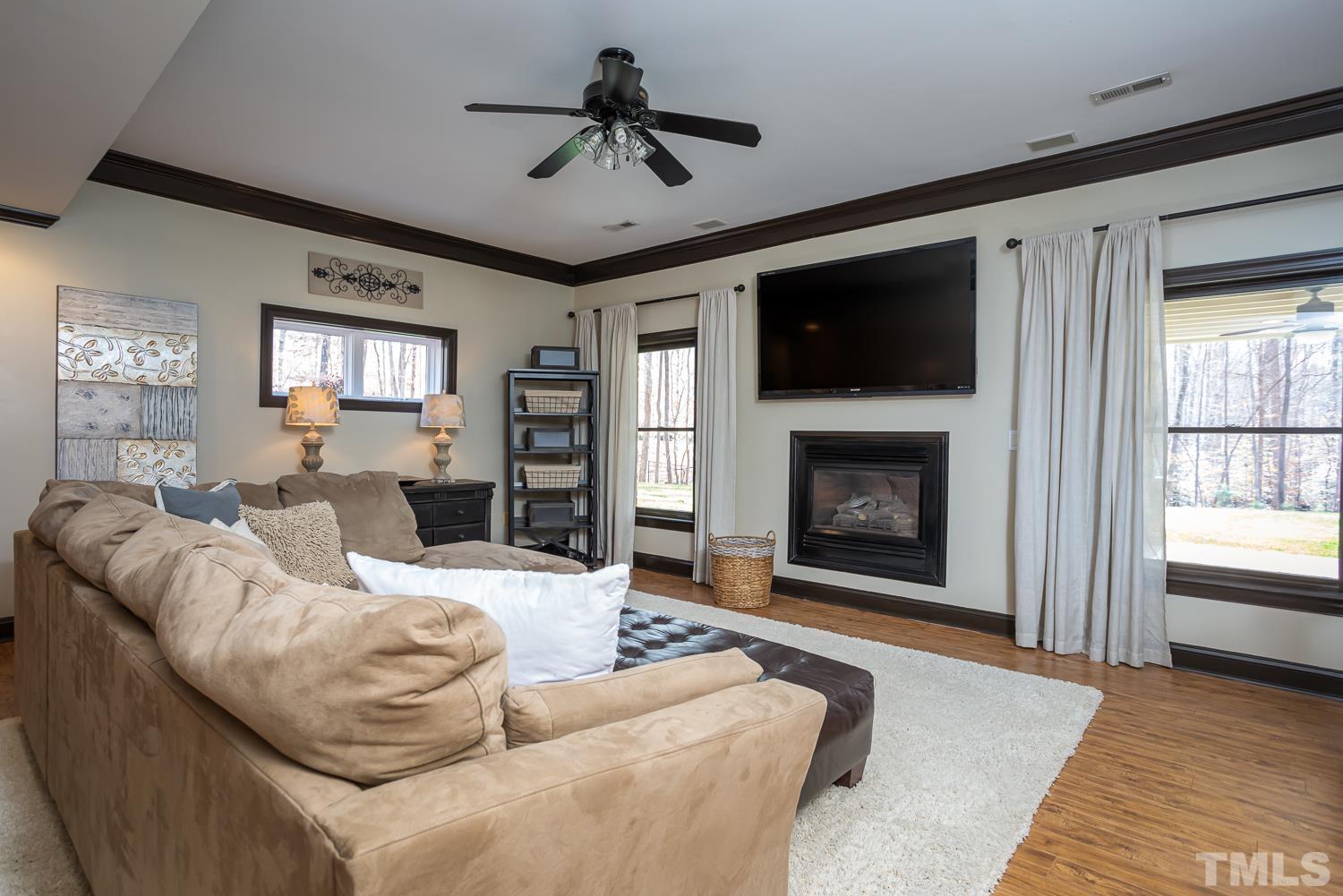 1616 Morning Mountain Road Raleigh, NC 27614 - Photo 45 of 86 a living room with furniture a flat screen tv and a fireplace