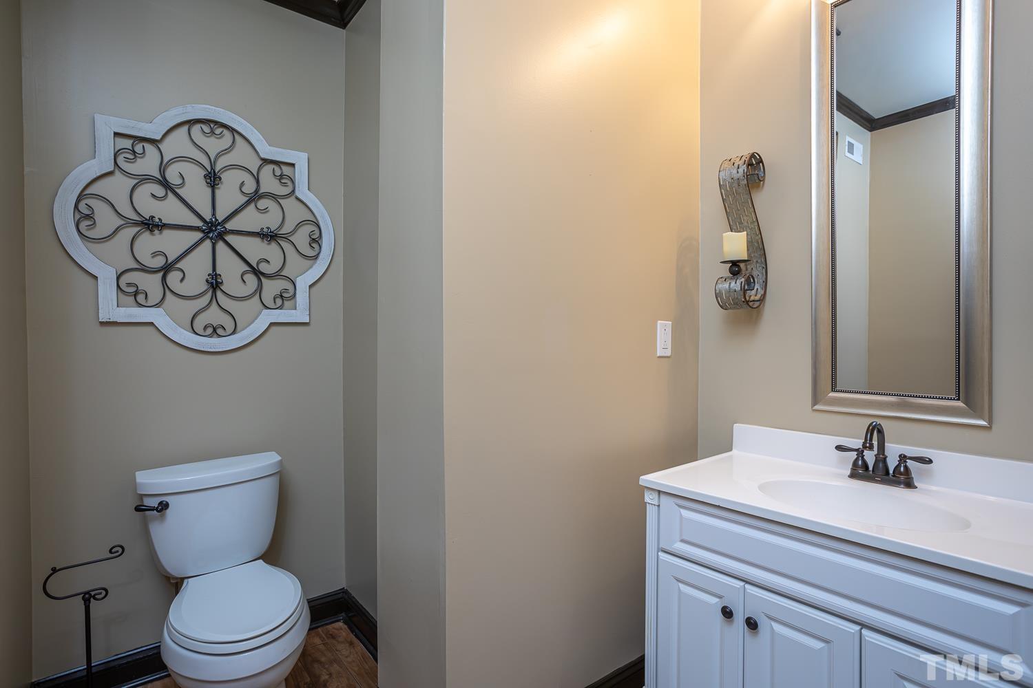 1616 Morning Mountain Road Raleigh, NC 27614 - Photo 49 of 86 a bathroom with a toilet sink and a mirror