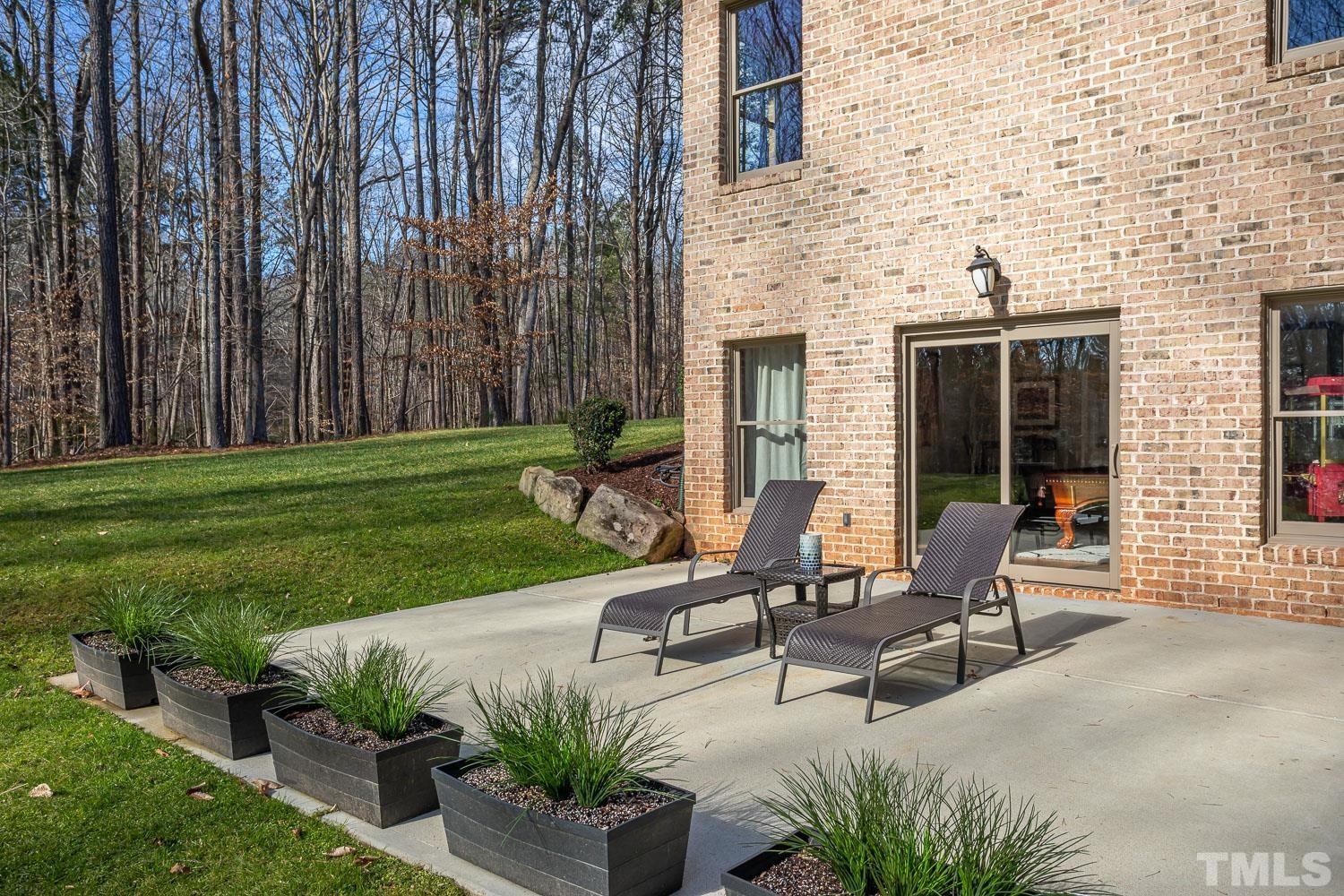 1616 Morning Mountain Road Raleigh, NC 27614 - Photo 69 of 86 a view of a patio with table and chairs with wooden fence and plants