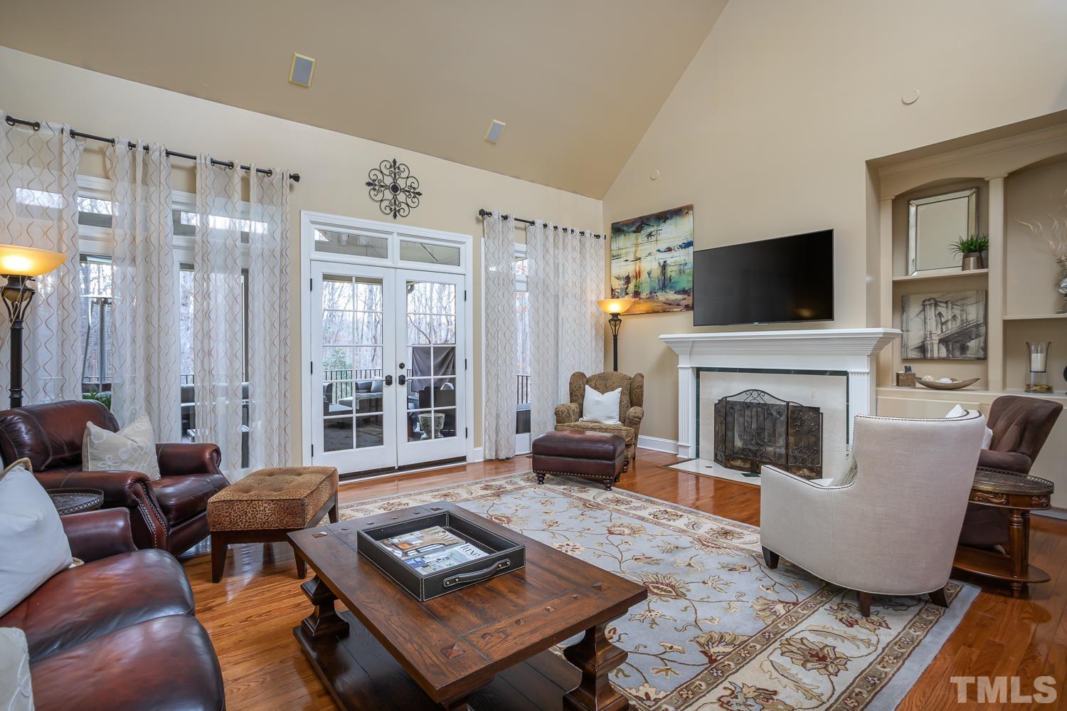 1616 Morning Mountain Road Raleigh, NC 27614 - Photo 10 of 86 a living room with furniture a flat screen tv and a fireplace