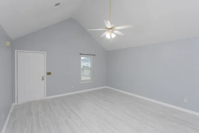 a view of backyard of house with green space