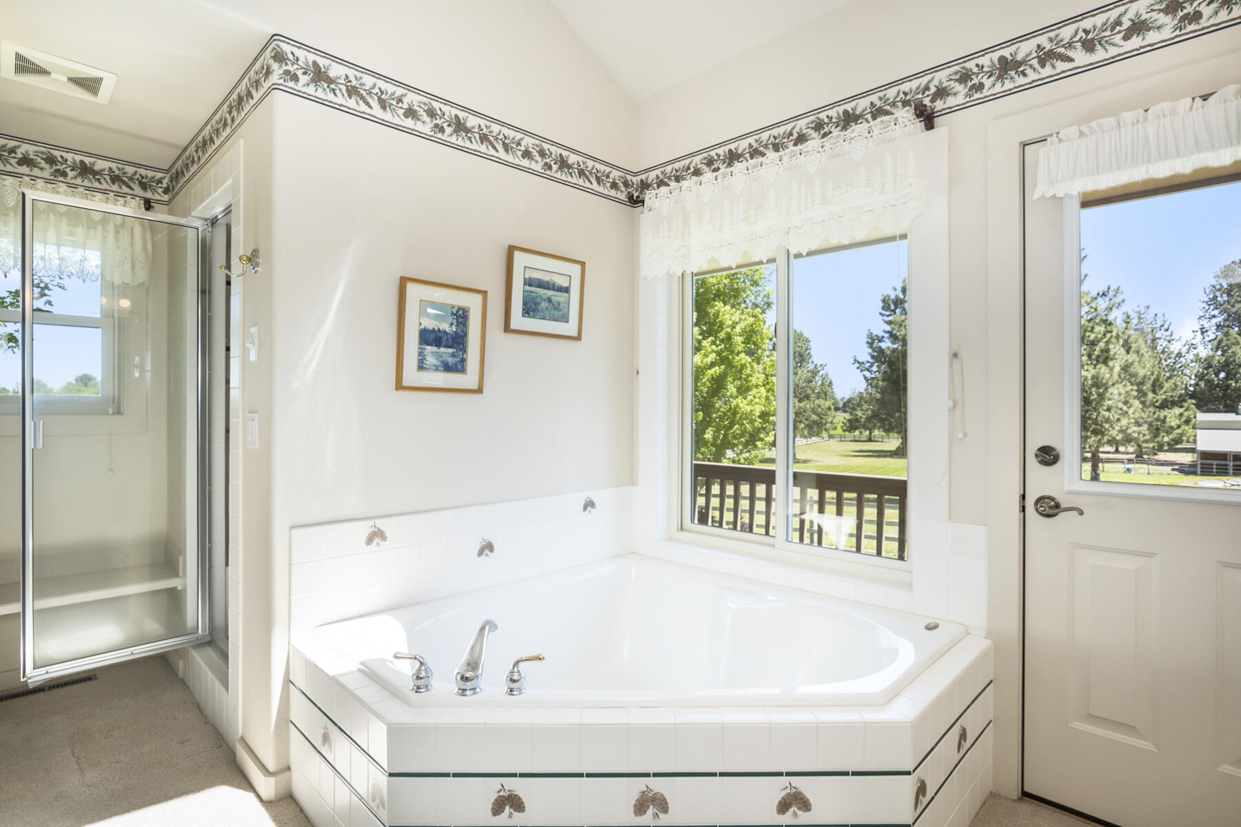 60696 Tekampe Road Bend, OR 97702 - Photo 23 of 61 a bathroom with a bathtub and a shower