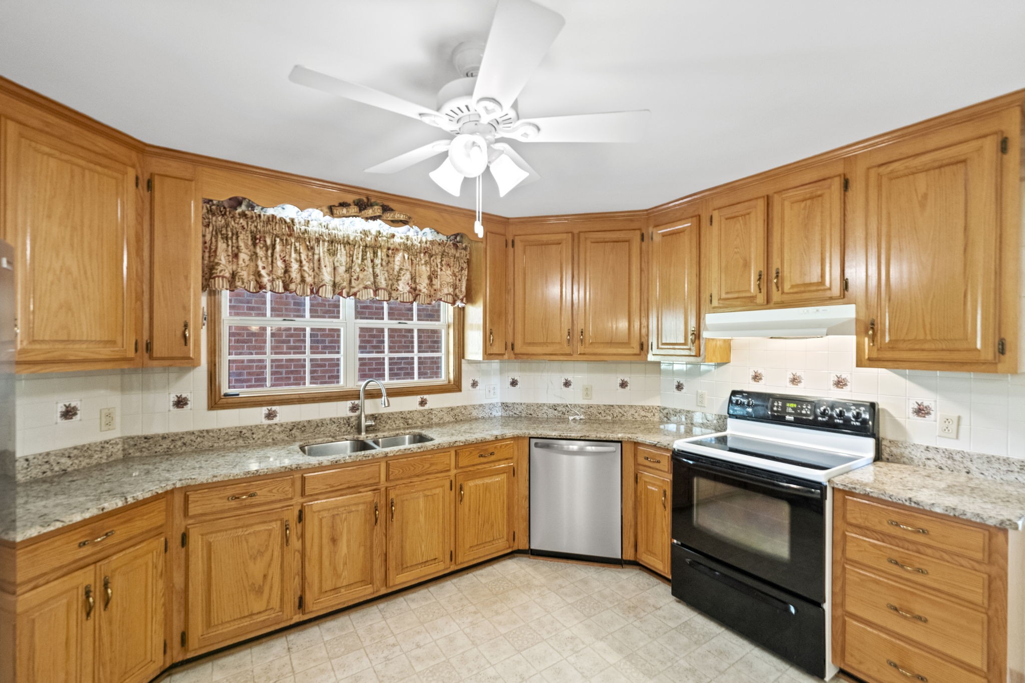 9139 Owens Chapel Road Springfield, TN 37172 - Photo 17 of 29 a kitchen with a sink stove and cabinets