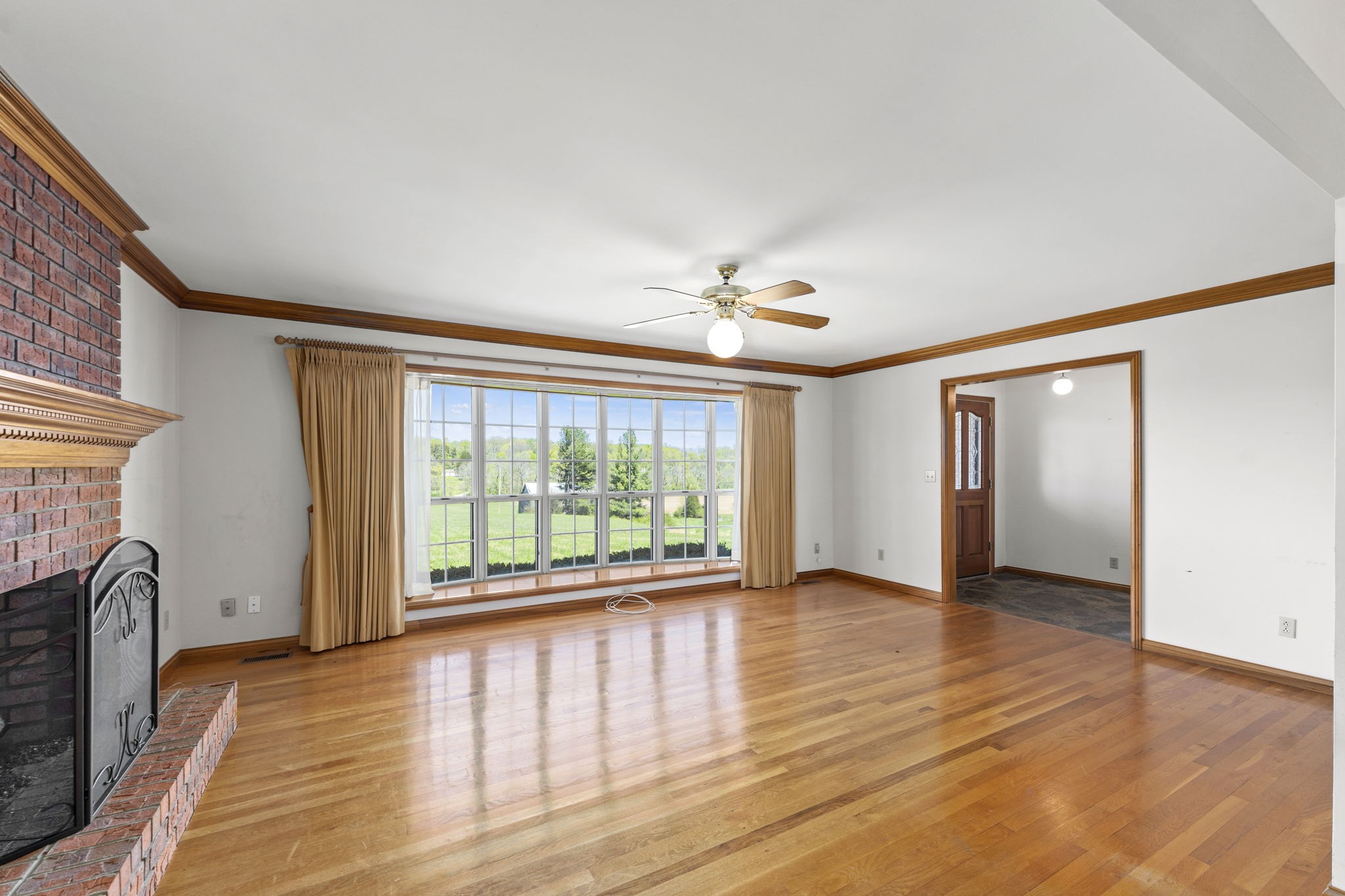 9139 Owens Chapel Road Springfield, TN 37172 - Photo 20 of 29 a view of an empty room with a window and wooden floor