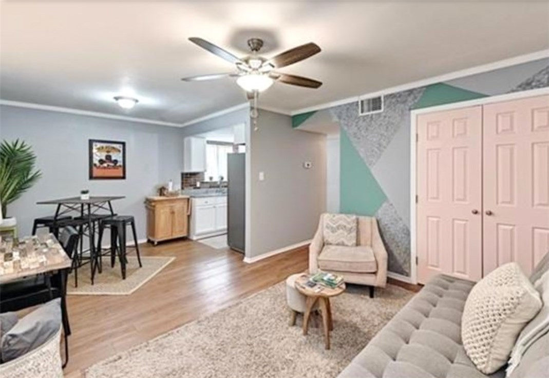 a living room with furniture and wooden floor