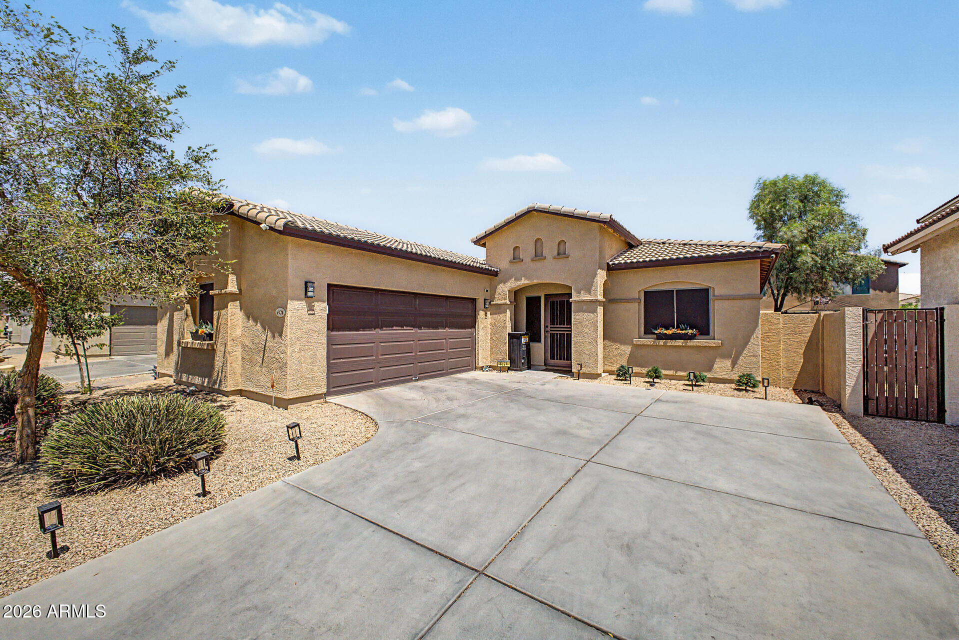 4924 West Harwell Road Laveen, AZ 85339 - Photo 3 of 27 a front view of a house with a yard and garage