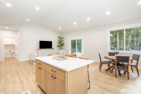 a view of kitchen with sink dining table and chairs