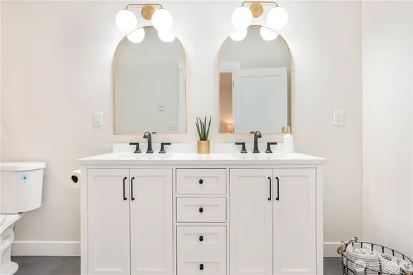 a bathroom with a sink vanity and a mirror