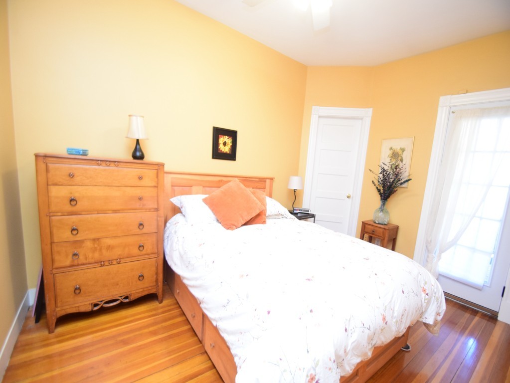 17 Strathmore Road, Unit 1 Brookline, MA 02445 - Photo 11 of 19 a bedroom with a bed and a mirror