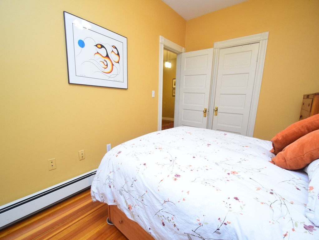 17 Strathmore Road, Unit 1 Brookline, MA 02445 - Photo 12 of 19 a bedroom with a bed and painting on the wall