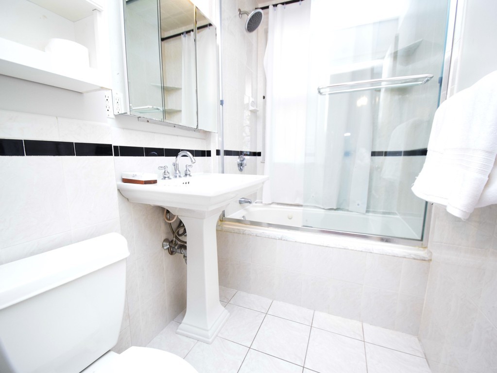 17 Strathmore Road, Unit 1 Brookline, MA 02445 - Photo 13 of 19 a bathroom with a sink toilet and shower