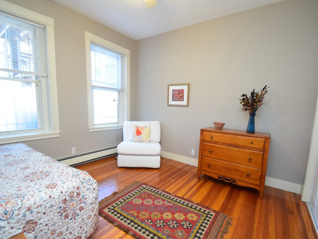 17 Strathmore Road, Unit 1 Brookline, MA 02445 - Photo 15 of 19 a bedroom with a bed and wooden floor