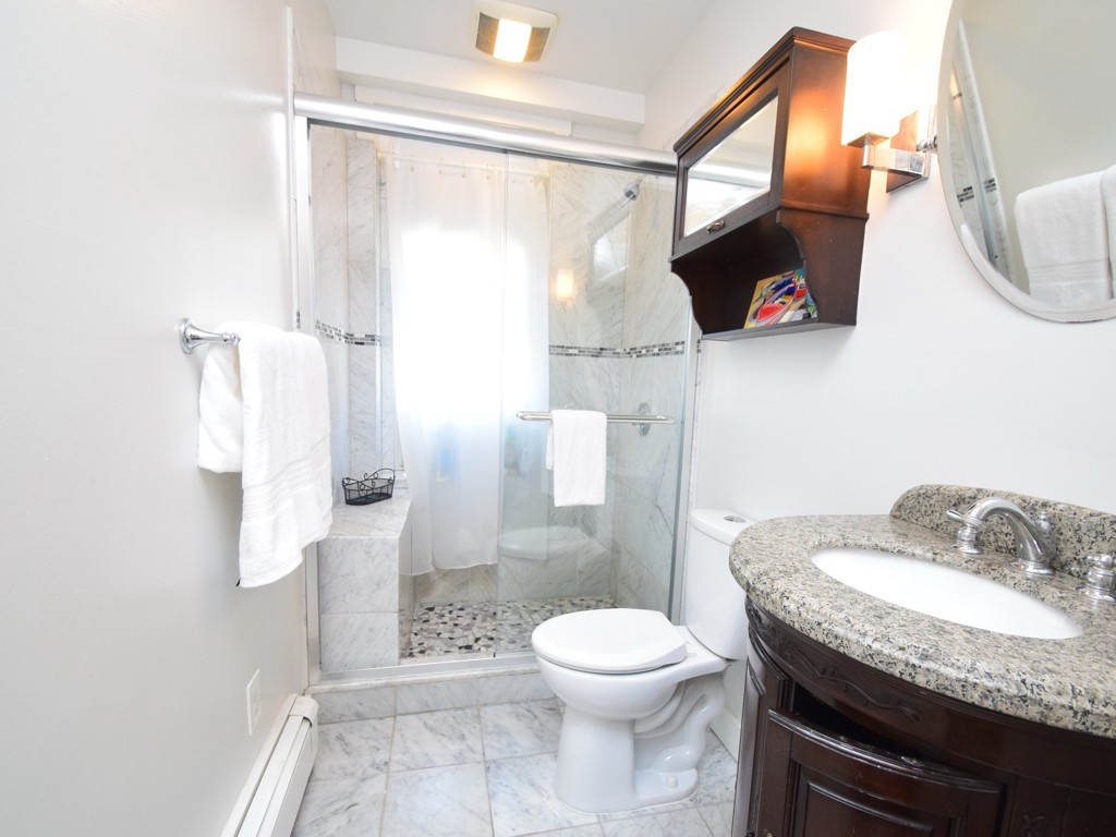 17 Strathmore Road, Unit 1 Brookline, MA 02445 - Photo 16 of 19 a bathroom with a granite countertop sink toilet and shower