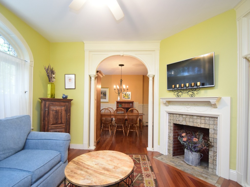 17 Strathmore Road, Unit 1 Brookline, MA 02445 - Photo 3 of 19 a living room with furniture a fireplace and a flat screen tv