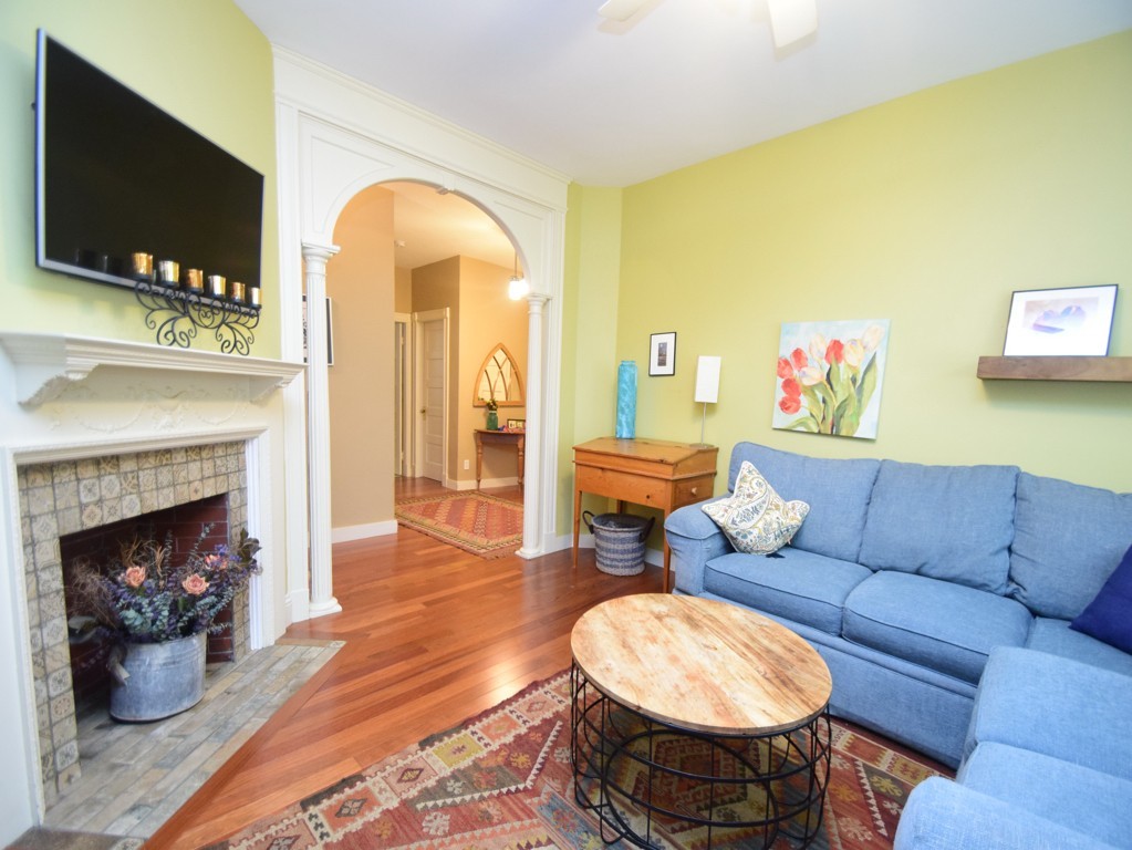 17 Strathmore Road, Unit 1 Brookline, MA 02445 - Photo 4 of 19 a living room with furniture and a fireplace