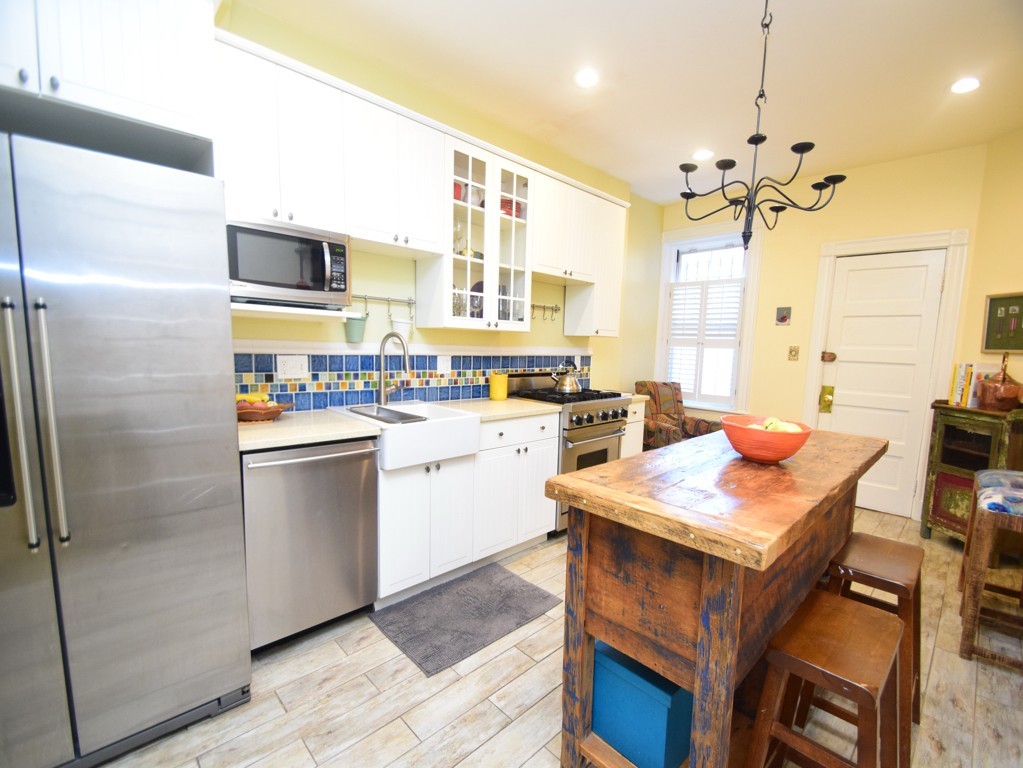 17 Strathmore Road, Unit 1 Brookline, MA 02445 - Photo 9 of 19 a kitchen with a sink appliances and cabinets