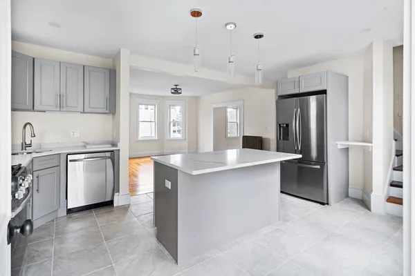 a kitchen with stainless steel appliances granite countertop a refrigerator stove and sink