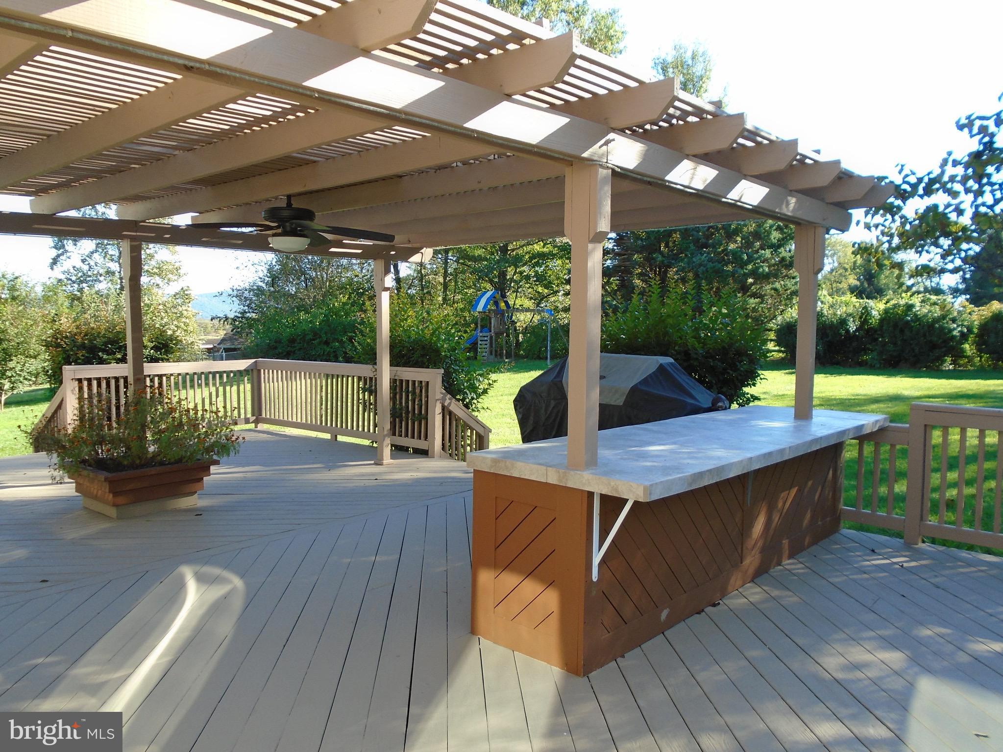 640 Keyes Ferry Road Charles Town, WV 25414 - Photo 6 of 27 rear deck has island for eating and partial cover