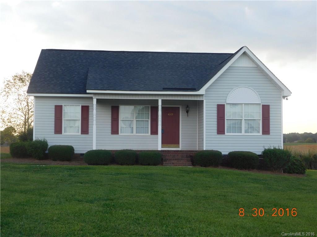 4007 Watson Church Road Monroe, NC 28110 - Photo 1 of 3 a house that is sitting in front of a big yard with potted plants