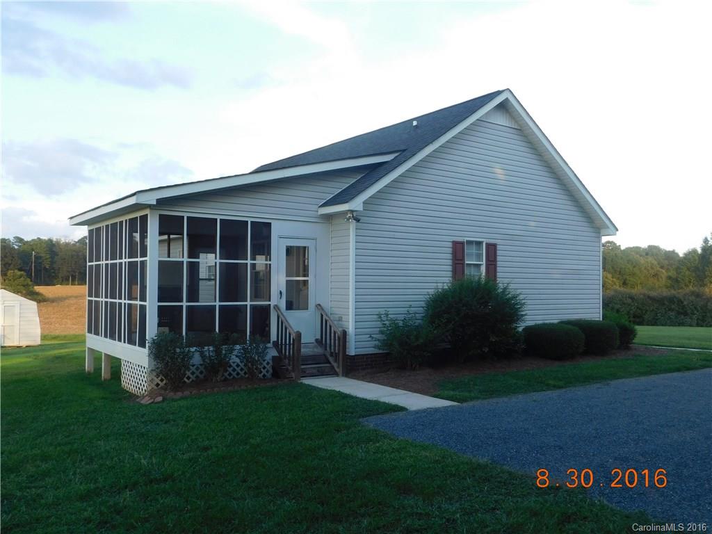 4007 Watson Church Road Monroe, NC 28110 - Photo 2 of 3 a view of backyard with potted plants and wooden fence