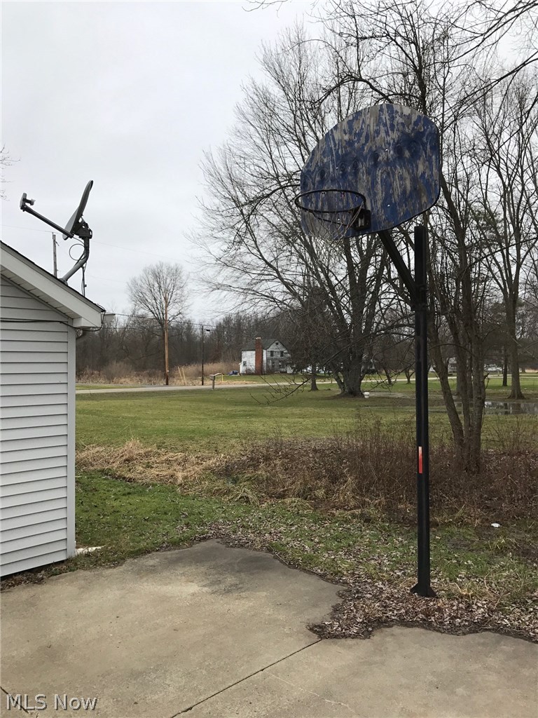 6120 Shaffer Road Northwest Warren, OH 44481 - Photo 22 of 24 Concrete pad and in-ground basketball pole. Note satellite receiver dish on roof.
