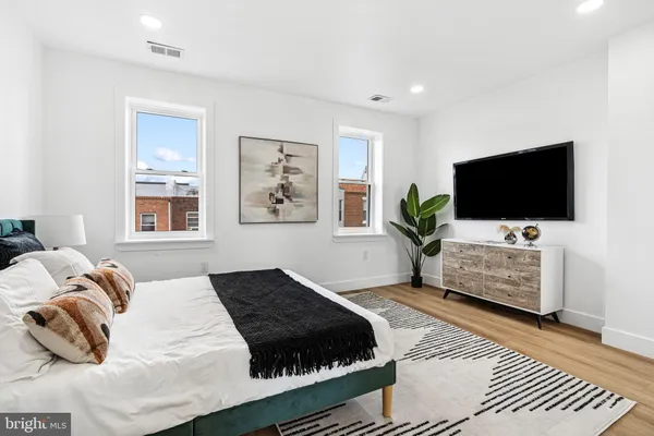 a bedroom with a bed and a flat screen tv