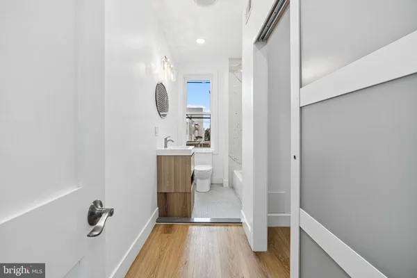 a bathroom with a sink a mirror and shower