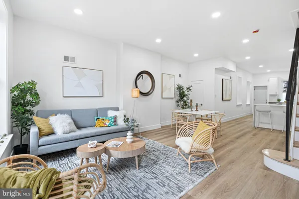 a living room with furniture and wooden floor