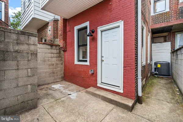 a view of a house with a door and wooden walls