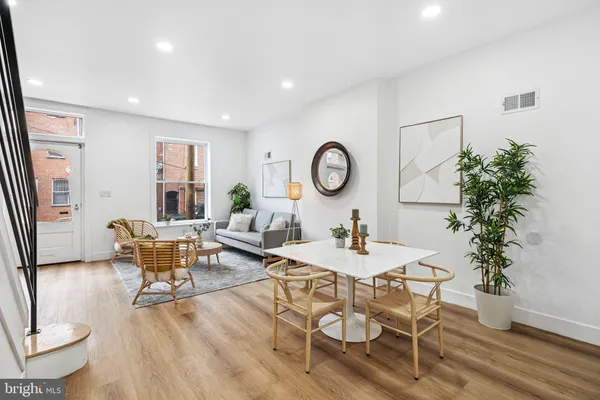 a living room with furniture and a potted plant