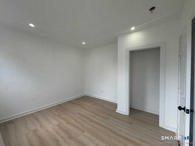 142 Cowles Street Bridgeport, CT 06607 - Photo 12 of 14 wooden floor in an empty room with a window