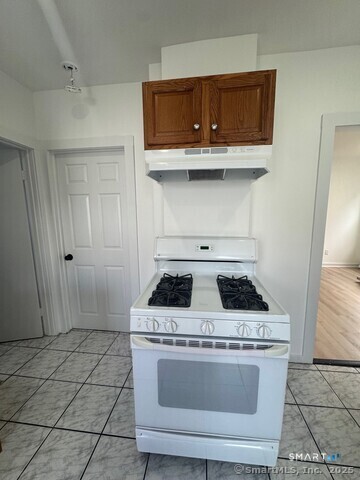 142 Cowles Street Bridgeport, CT 06607 - Photo 9 of 14 a stove top oven sitting inside of a kitchen