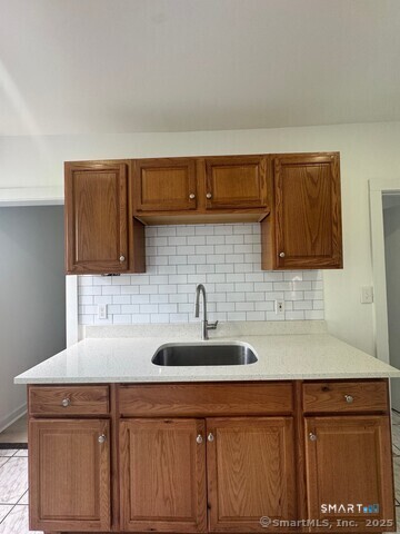 142 Cowles Street Bridgeport, CT 06607 - Photo 9 of 14 a kitchen with a sink and cabinets