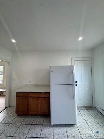 142 Cowles Street Bridgeport, CT 06607 - Photo 10 of 14 a kitchen with a refrigerator and a refrigerator