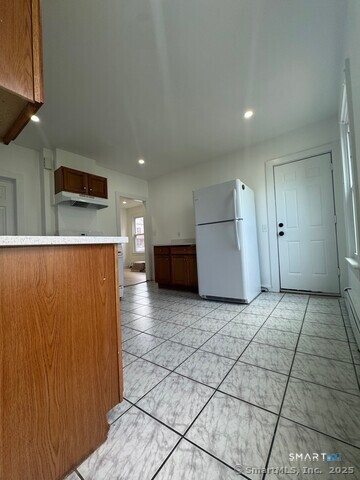142 Cowles Street Bridgeport, CT 06607 - Photo 10 of 14 a view of a refrigerator in kitchen