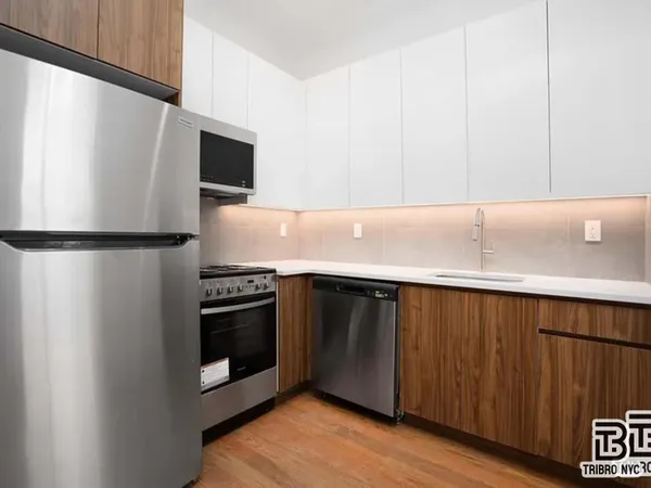 a kitchen with stainless steel appliances a refrigerator and a microwave