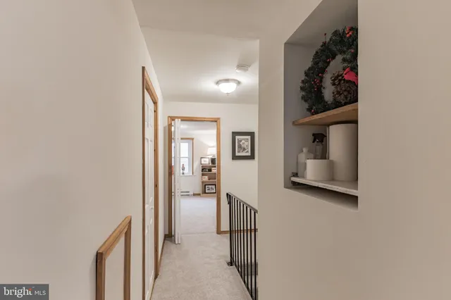 a view of a hallway with closet and mirror