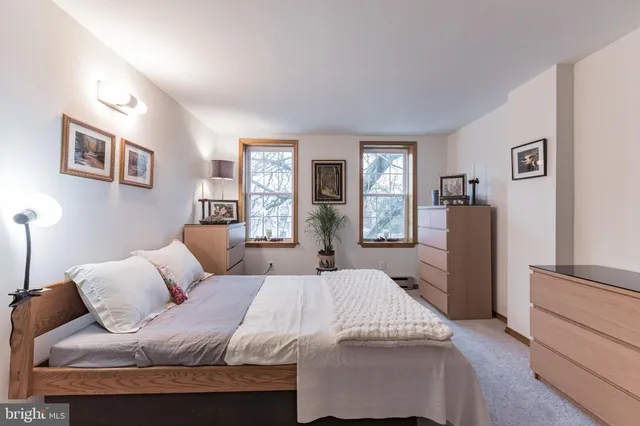 a bedroom with a large bed and a couch