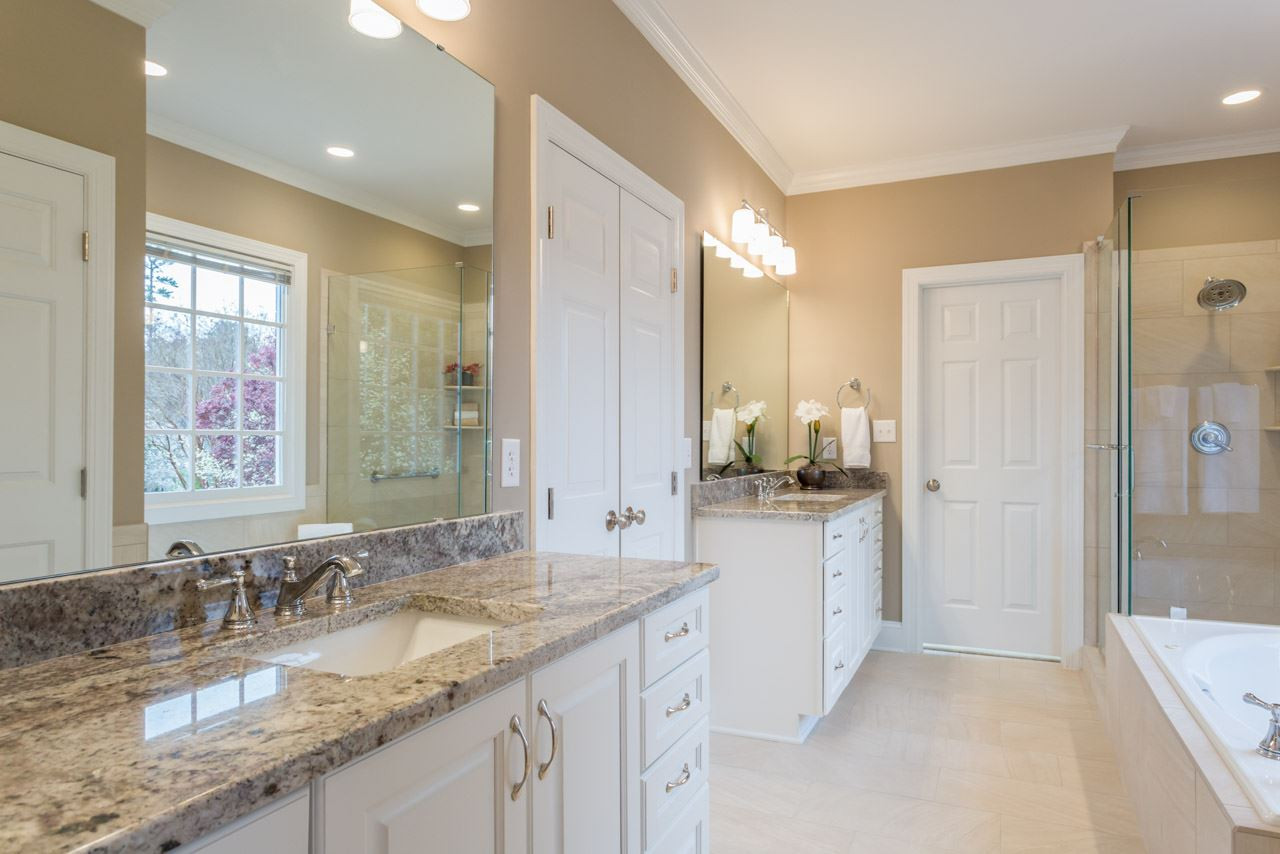 8704 Carriage Tour Lane Raleigh, NC 27615 - Photo 18 of 25 Newly updated with tasteful tile, double sinks, cabinets, granite, shower and fixures. A place to pamper yourself. Master Bath/Spa