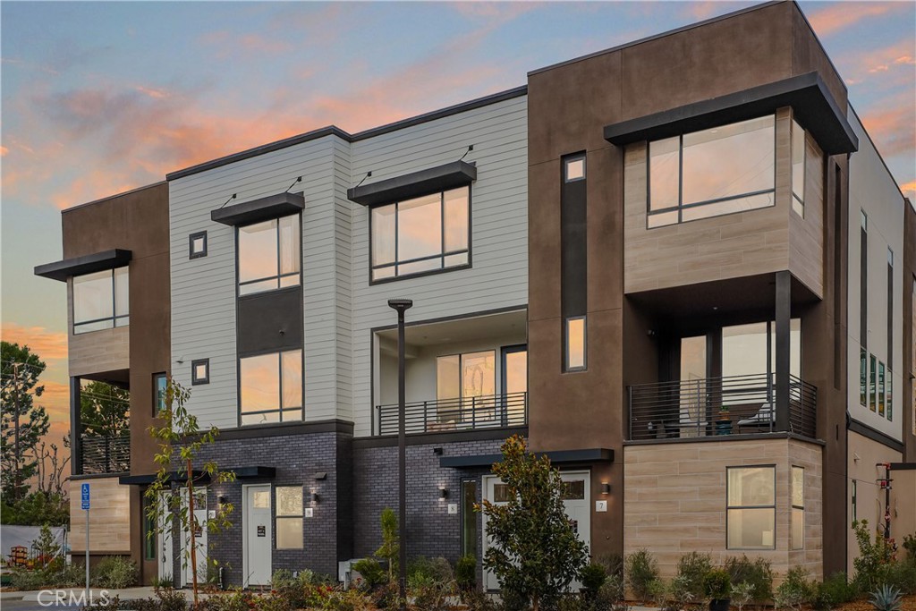 a front view of a residential apartment building with a yard
