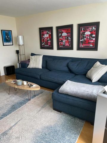 a living room with furniture and wall paintings